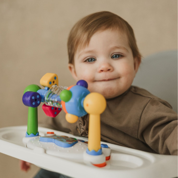 Parent feeding baby using adjustable bouncer with feeding position