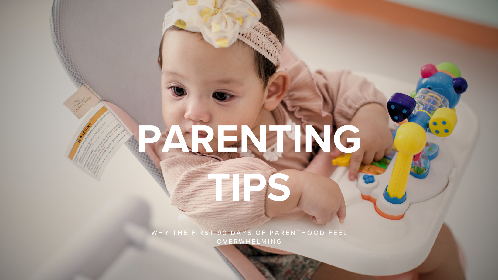 Newborn resting in a portable infant lounger.