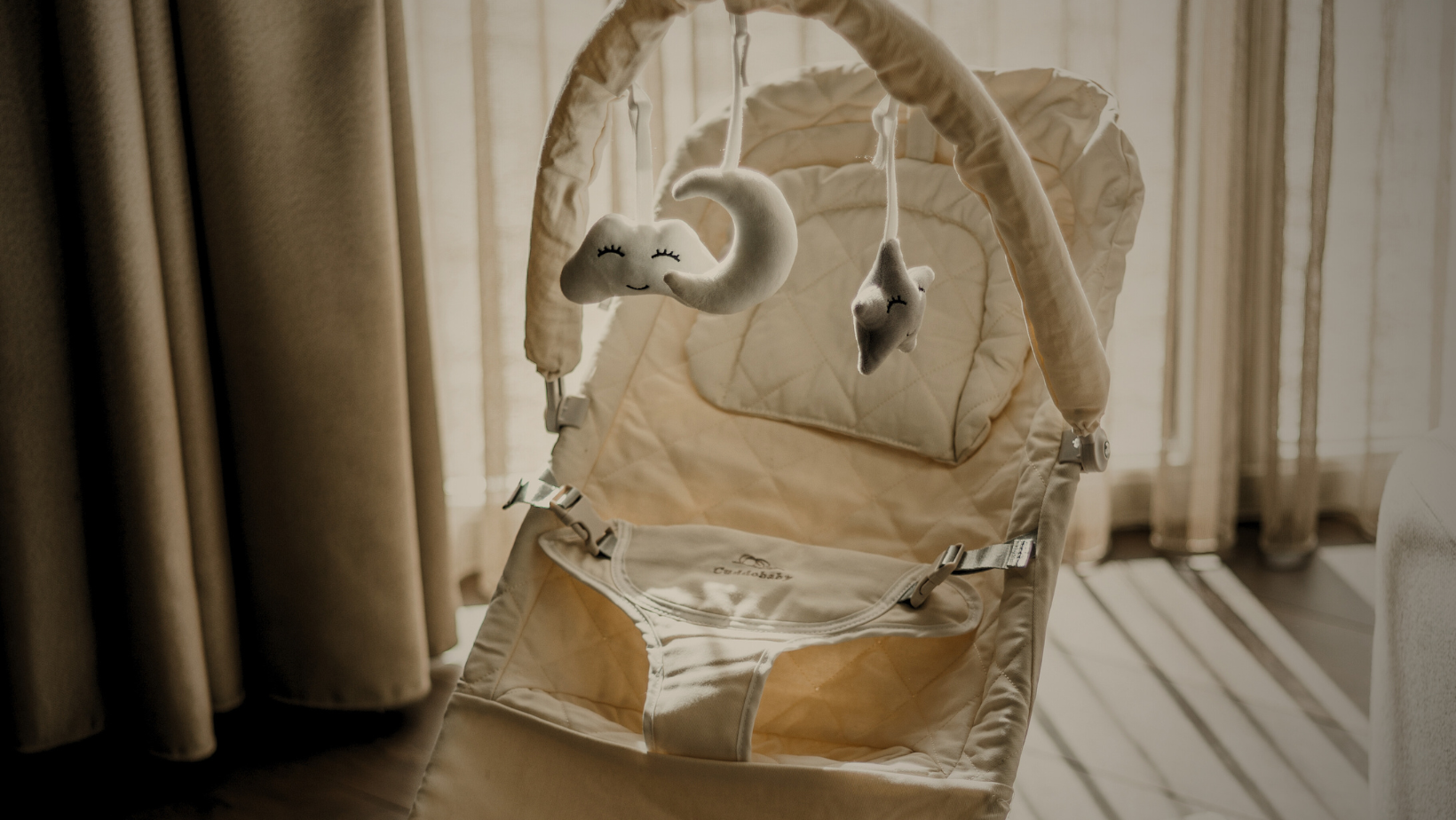 The 4-in-1 bouncer folded flat against a wall for storage.